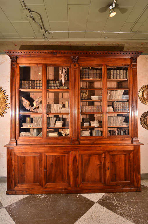 Large and Handsome Walnut Biblioteque All Hand Pegged and With Original Glass. Restauration to Directoire Period.Beautiful Patina,Very Refined Carving to The Front.