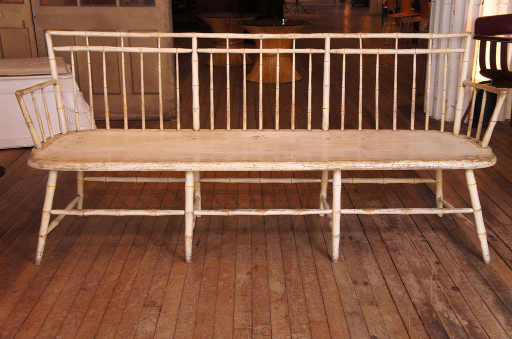 delicate bamboo turned american windsor bench - 
in the birdcage style -
one board seat - 
original white painted surface - 
with yellow ring accents