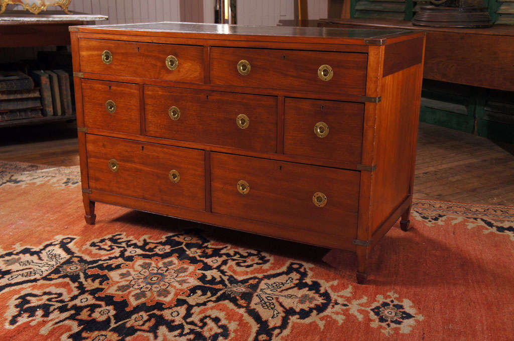 severe seven drawer mahogany campaign style chest - on spade feet - with brass attachments - recessed green leather top - dovetailed drawers - paneled back