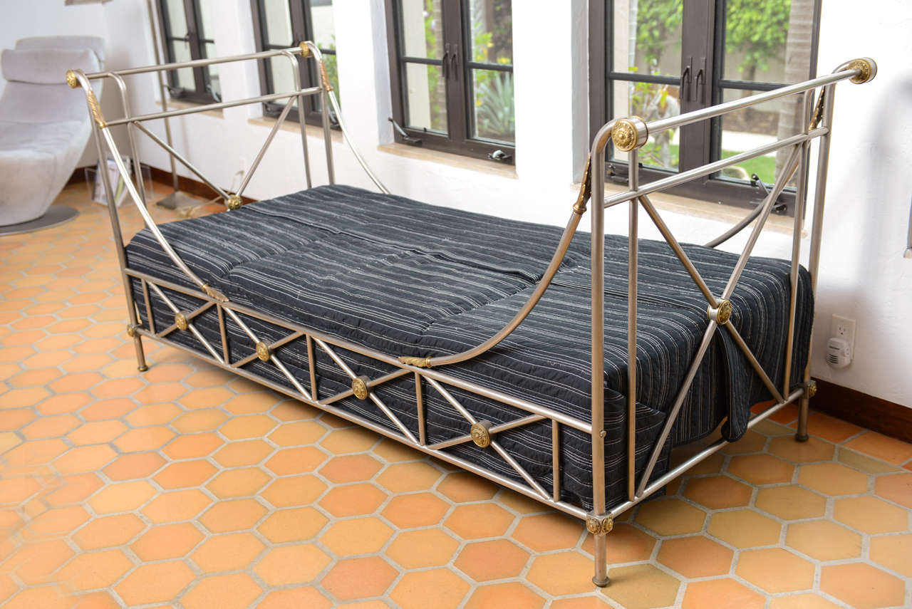 Campaign style daybed of brushed steel with bronze accents by Maison Jansen.  Includes custom made floral cushions which need recovering.  Black coverlet (shown) not included.  Reduced from $8,000.00.

Please feel free to contact us directly for a