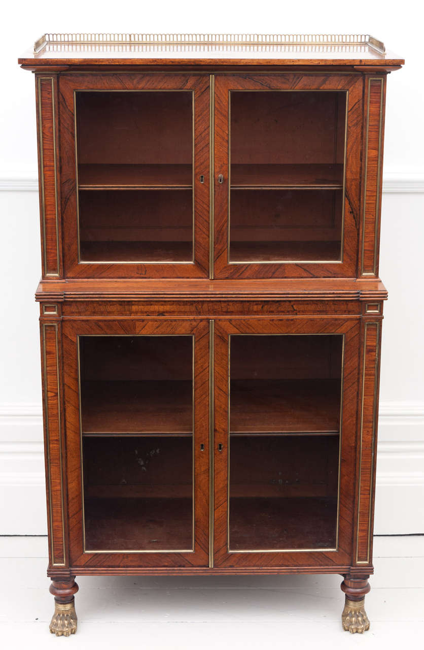 A very fine Regency Rosewood brass encased baby bookcase, with  Yew wood feather banding in the manner of John Mclean.  Sold at Somerset House fair in 1979.  Documentation available.
