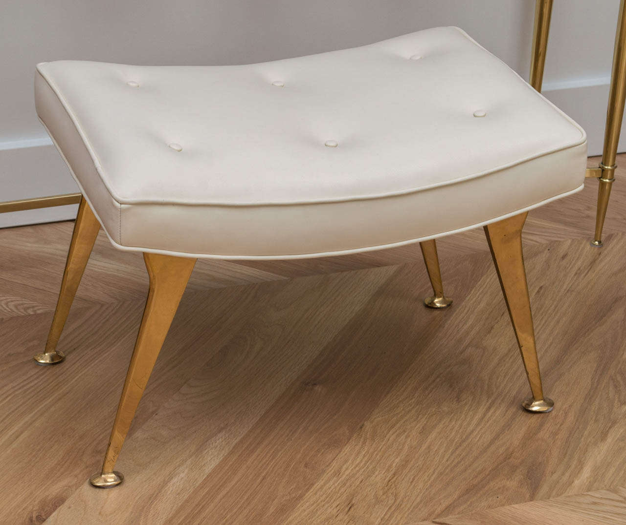 The perfect Italian brass stool in a cream colored leather.
