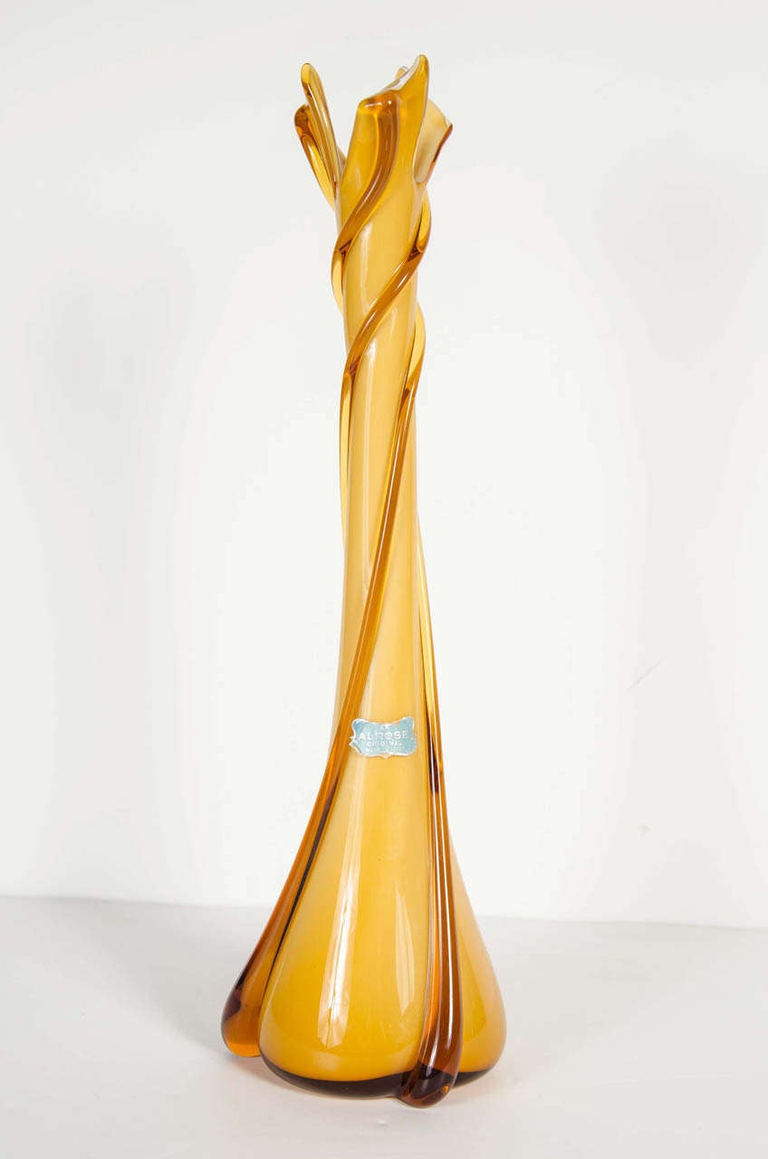 This hand blown Murano glass vase features a twisted spiral form in gorgeous hues of amber and creme.