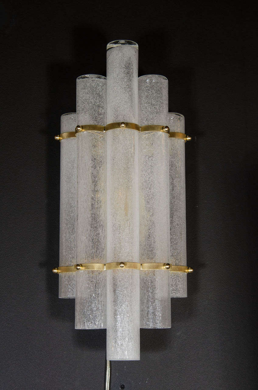 This stunning pair of sconces were handblown in Murano, Italy- the island off the coast of Venice renowned for centuries for its superlative glass production. They feature five staggered tubular Pulegoso textured translucent glass shades secured