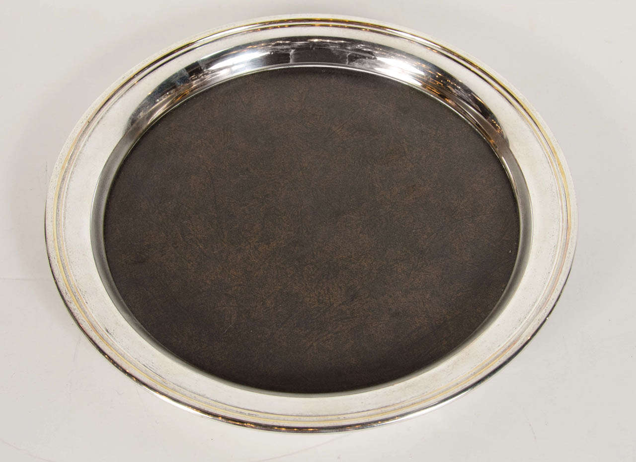 Mid-Century Modern round serving or bar tray by Crescent with a Micarta bottom that sits inside of a polished nickel surround. The exterior of the nickel surround has a streamlined stepped detail and features a slight slope design with a two-tiered
