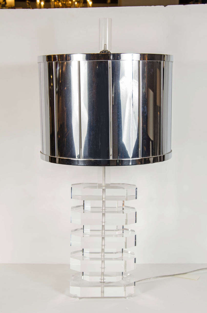 This beautiful table lamp features a geometric base of alternating small and big hexagon shaped lucite pieces and it's topped by a large circular lucite finial. It's original custom chrome shade makes this lamp a highly collectable and rare piece.