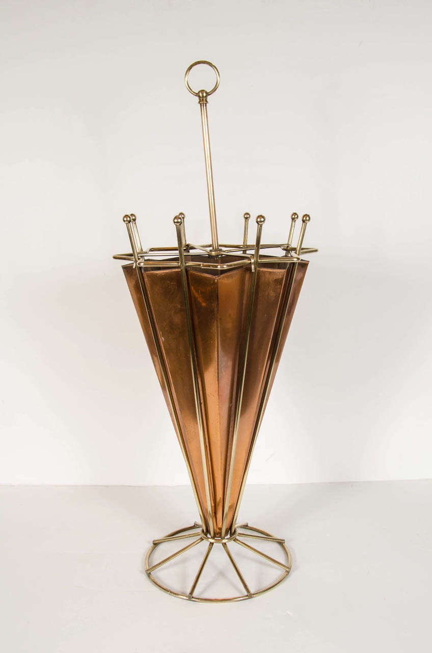 Beautifully stylized form umbrella stand in copper and brass in the form of an open umbrella with sitting on a round form base. This stand has been restored to mint condition.