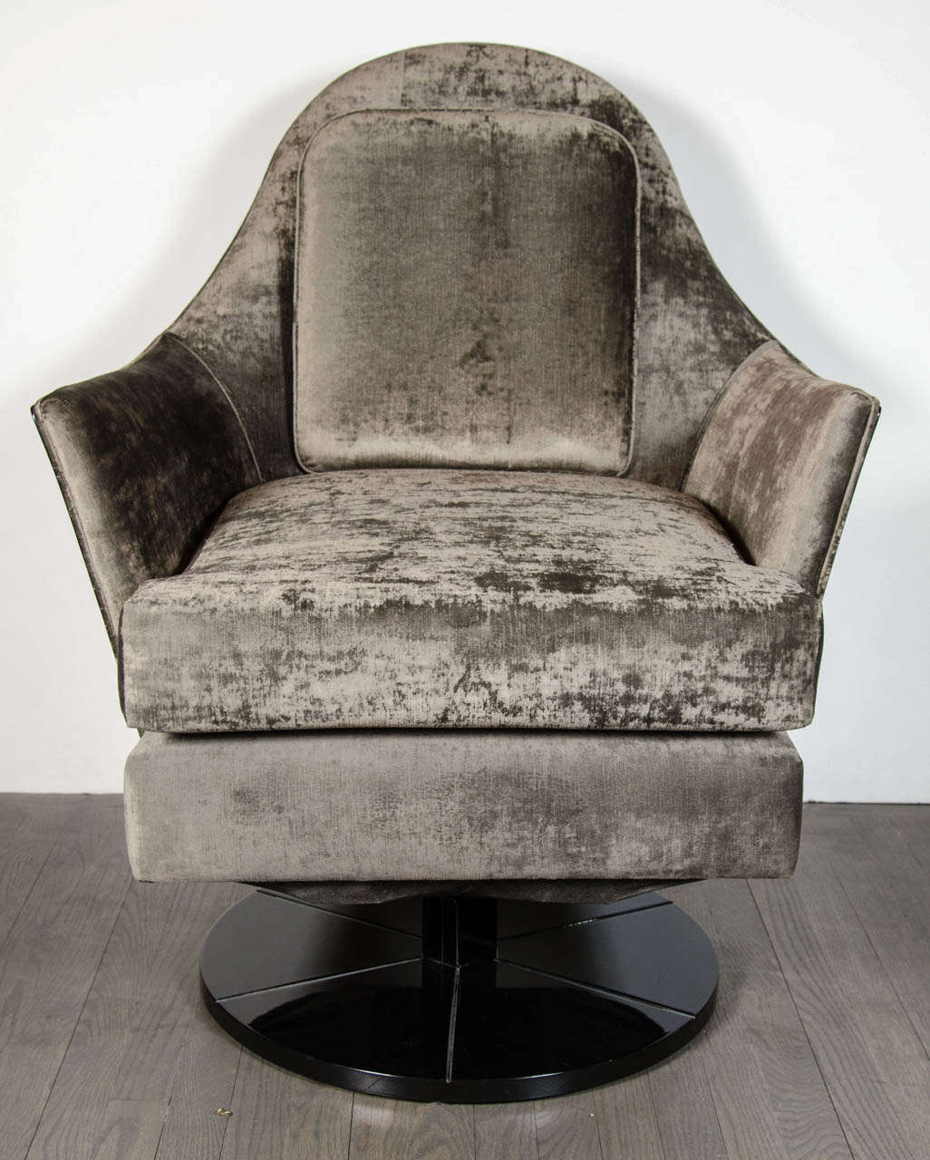 Pair of Mid-Century Modernist swivel / rocker arm chairs upholstered in a luxe smoked platinum velvet that is beautifully offset by their ebonized walnut frame and base.  These chairs have a round swivel and rocker base in ebonzied walnut that