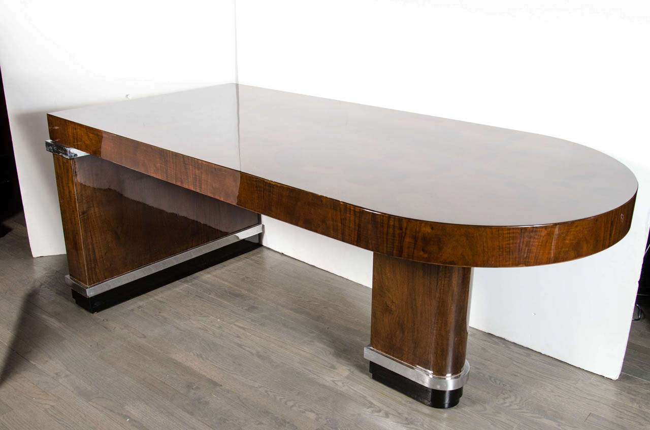 Outstanding and exquisite is the only way to describe this special desk.  The top features all exotic woods - rosewood, burled walnut, cuban mahogany all inlayed in a cubist Art Deco pattern.  The streamline design also features two nickel banded