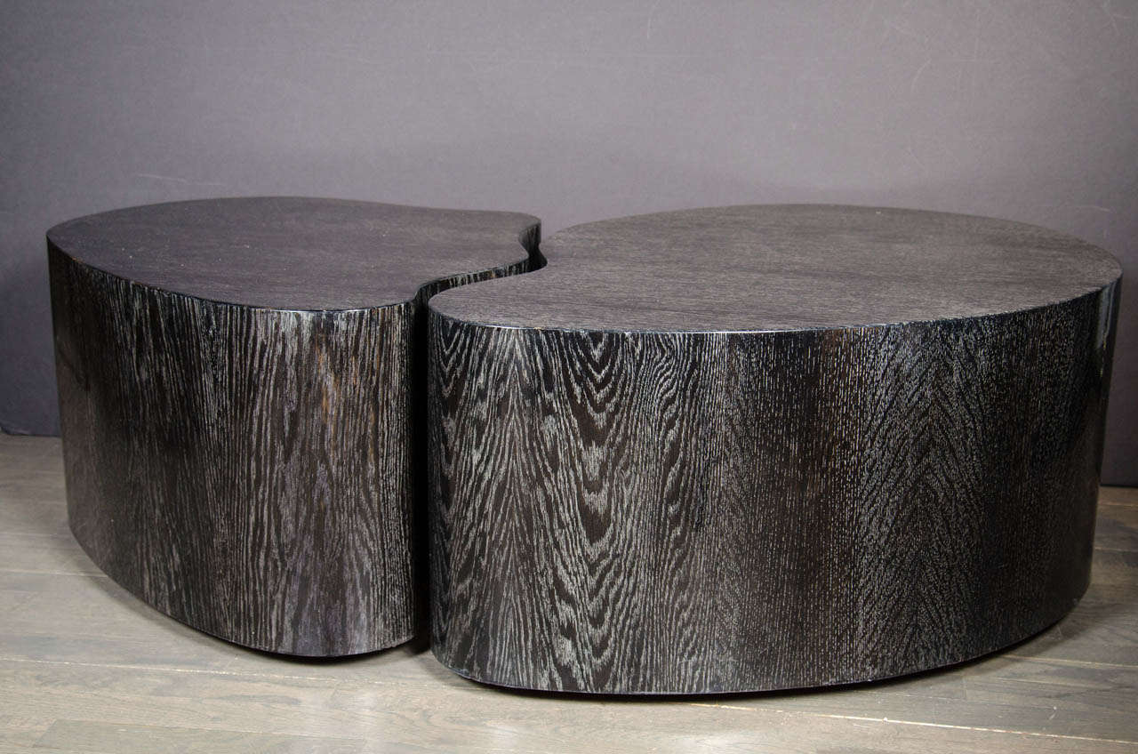 Mid-Century Modernst cocktail tables in a stunning silver cerused Oak finish.  This set of cocktail tables feature an organic free-form design with a center on each that meet to form a distinctive look.  They can be used in many different