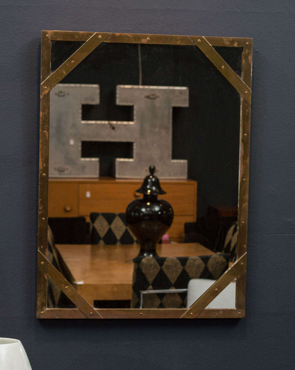 Stylish mirror made in Italy with a riveted brass frame, by Sarreid Ltd.