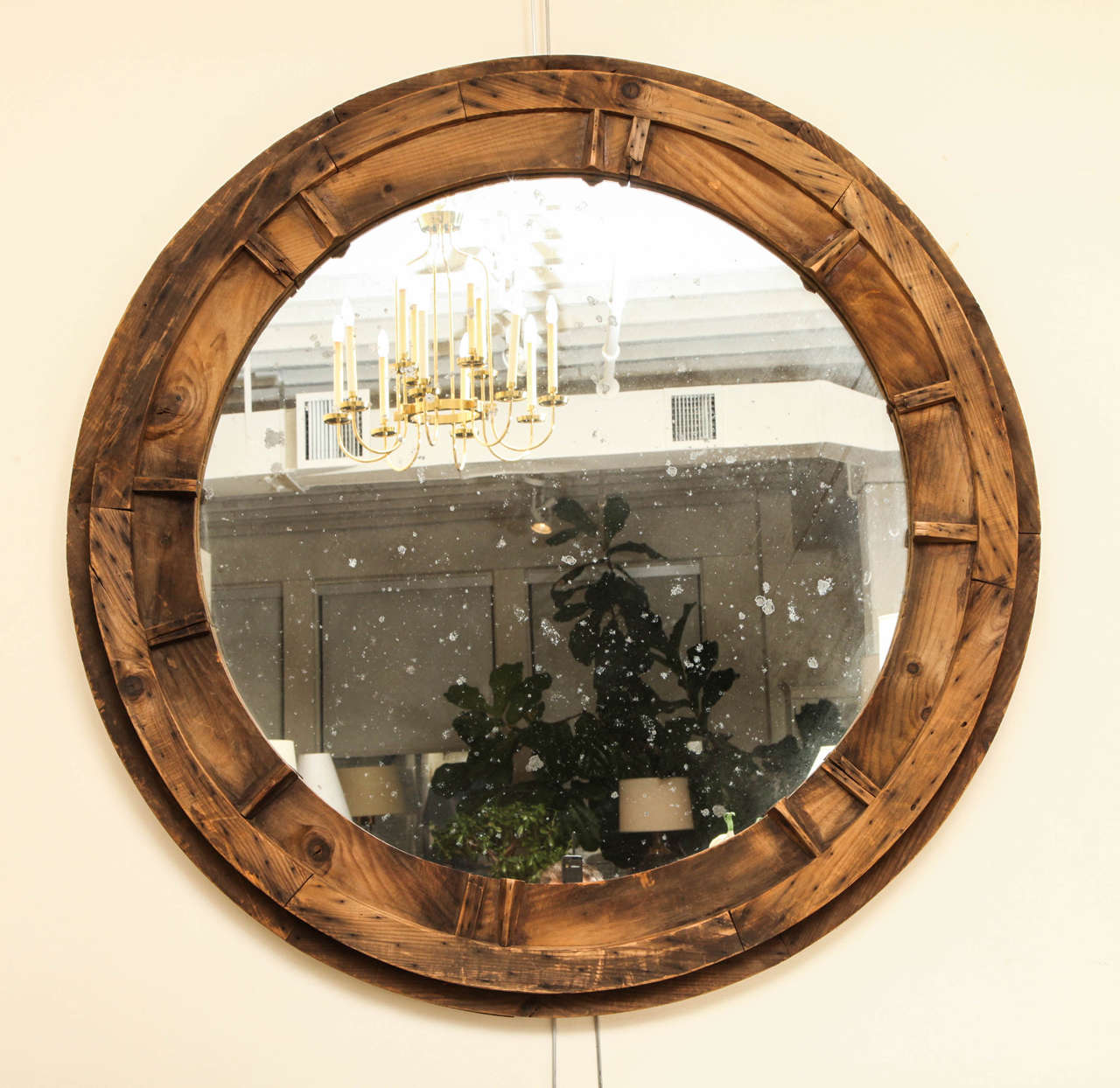 Large round rustic wooden sandmold mirror with antiqued mirror glass