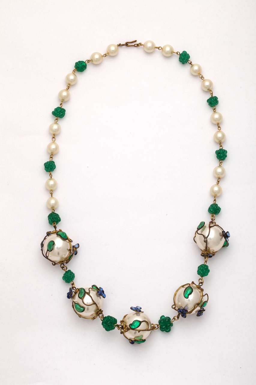 A fantastic early Chanel necklace with molded and poured glass fruit on a wire vine wrapping faux pearls