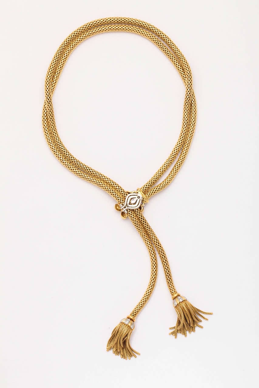 A stylish and elegant retro 18-karat woven gold double rope necklace with Italian hallmarks adjustable length with white gold, gold and diamond clip and ending with 3/4
