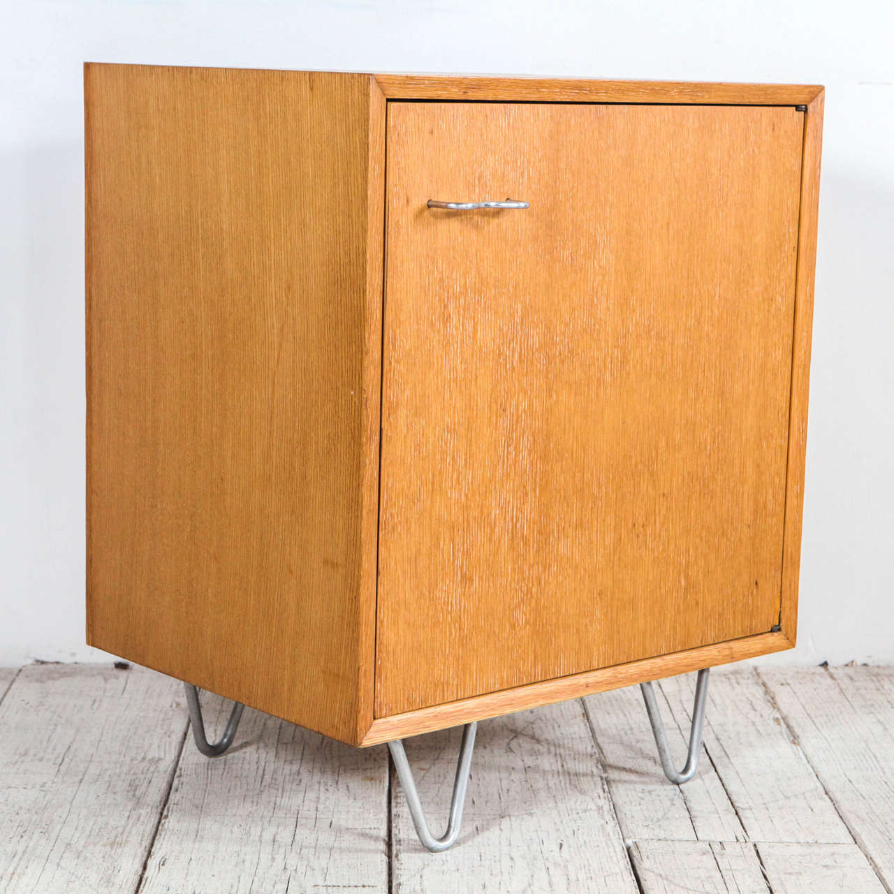 Midcentury side table / cabinet on metal hair pin legs with matching door hardware.