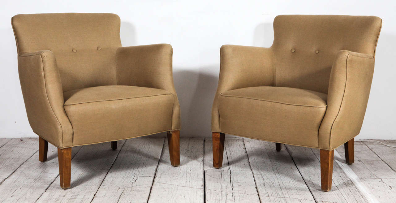 Pair of petite lounge chairs newly upholstered in neutral linen.