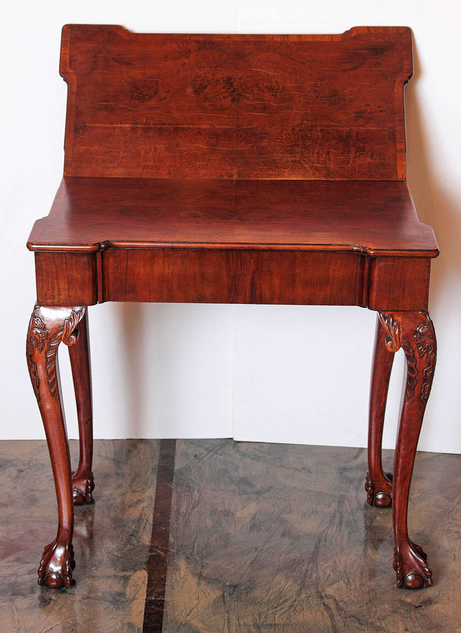 Pair of English burled walnut card tables .Ball and claw feet and carved knees