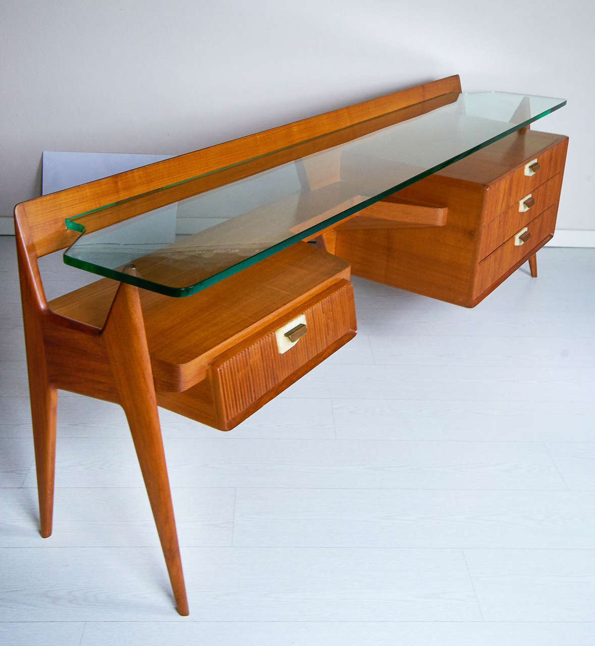 Beautiful build quality cherrywood, grooved drawers and handles in onyx and brass. The glass is very thick shaped and fits into the structure of the fourniture to self sustaining.
This kind of fourniture from versatile features can be used as a desk