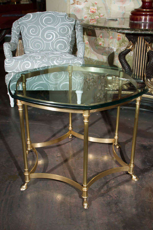 An elegant six sided hoof feet side table by La Barge. Glass is cut with six curved sides. Excellent design and construction.