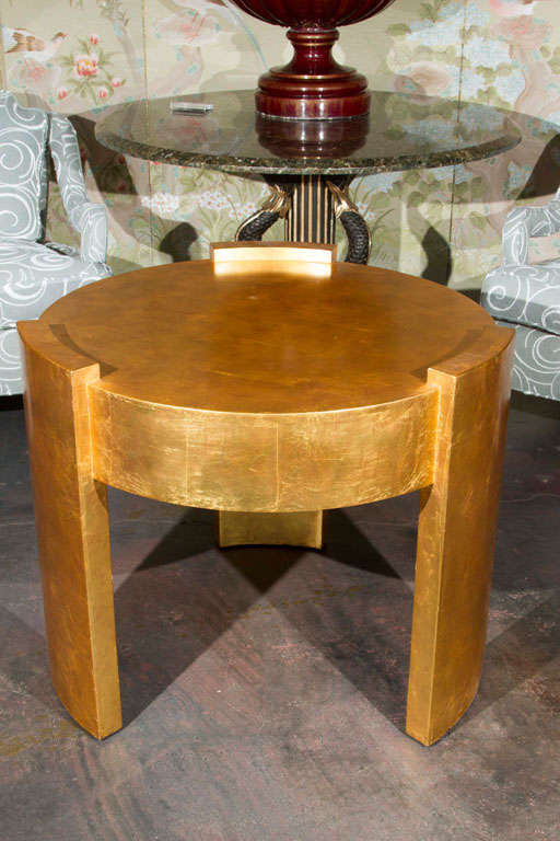 A gold leaf side table with three legs attributed to Joseph de Coene. Height of the table legs are 26 1/4