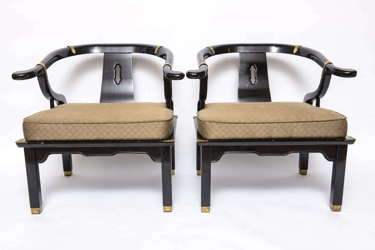 Beautiful black lacquered chairs styled like James Mont. Chairs have original upholstery and brass accidents.