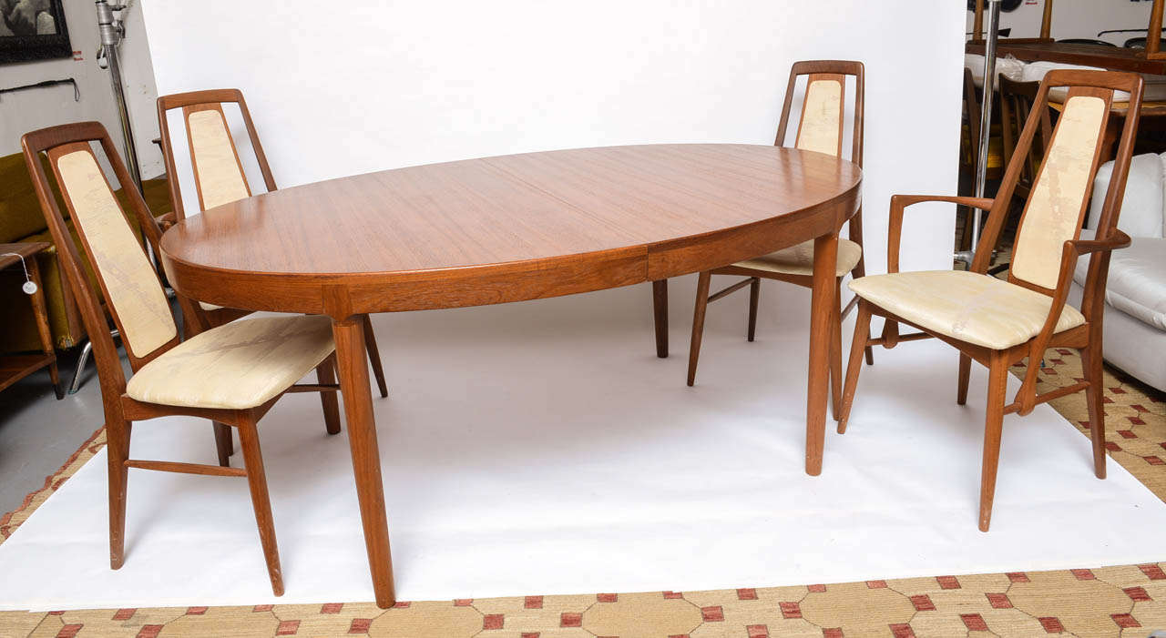 Beautiful teak dining room table with 2 leaves and 8 chairs by Koefoeds.