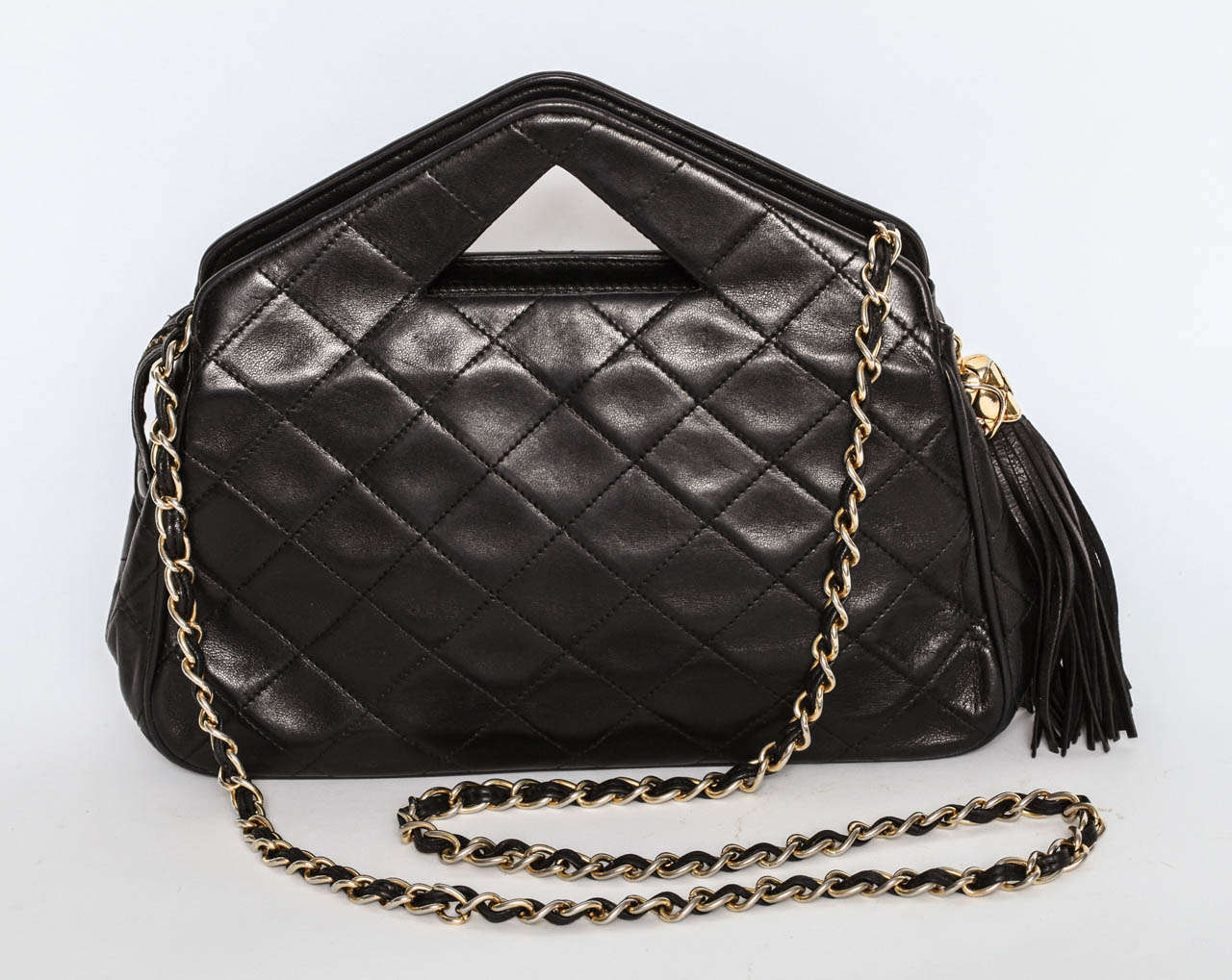 A fabulous black quilted Chanel bag with tassle and pyramid shaped handles.