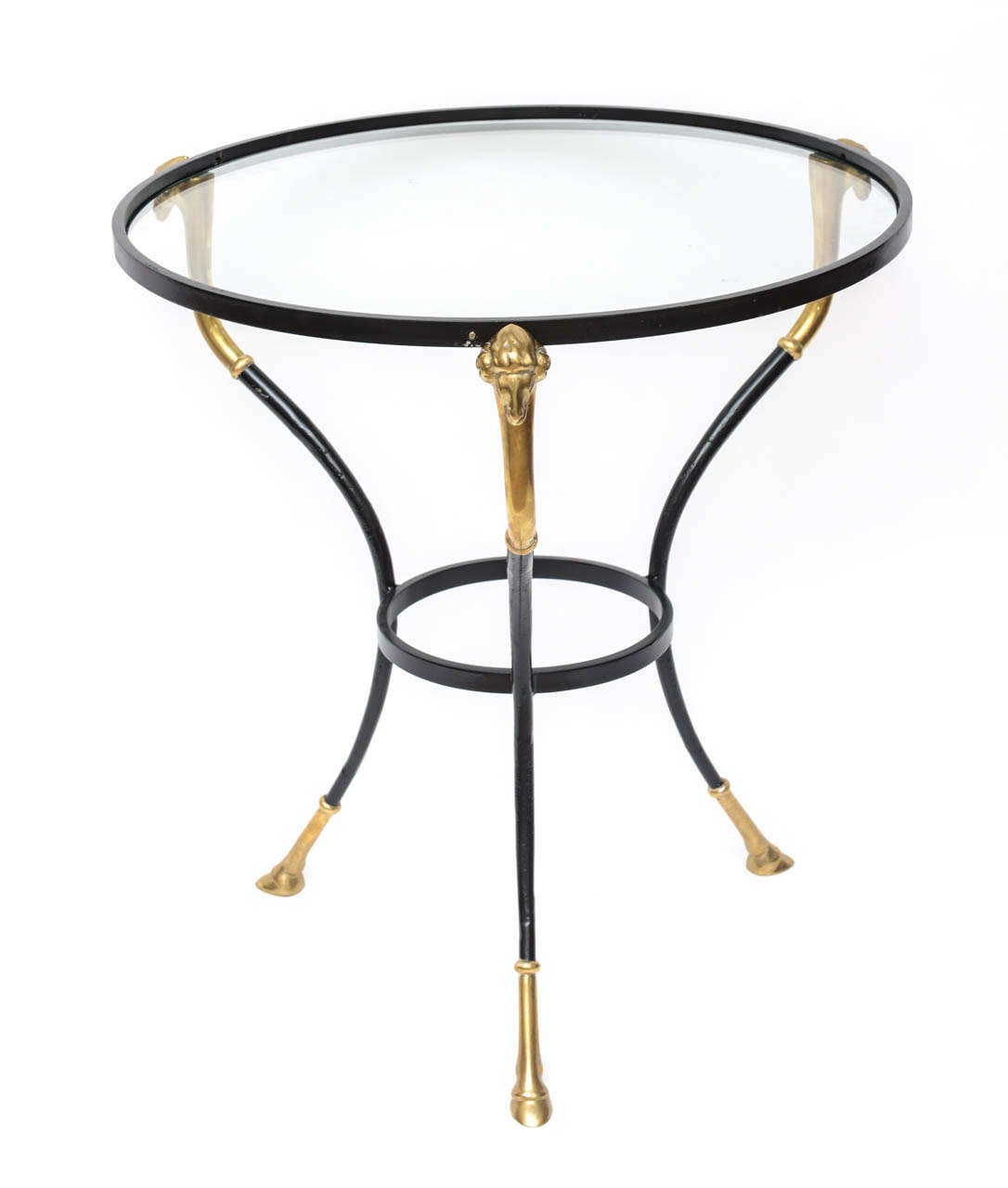 Italian cocktail or side table in iron with brass sabots in the form of ram's hoofs.
Tabletop is upheld with three ram's heads in brass. Tabletop surface is glass and sits loose on the base.
In good vintage condition with some scuffs to the black