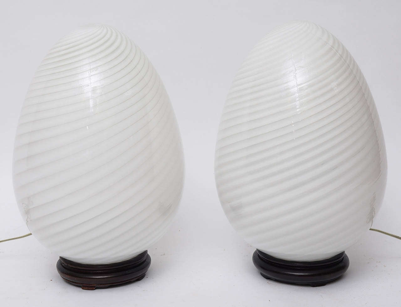 Pair of white swirled glass table lamps.
