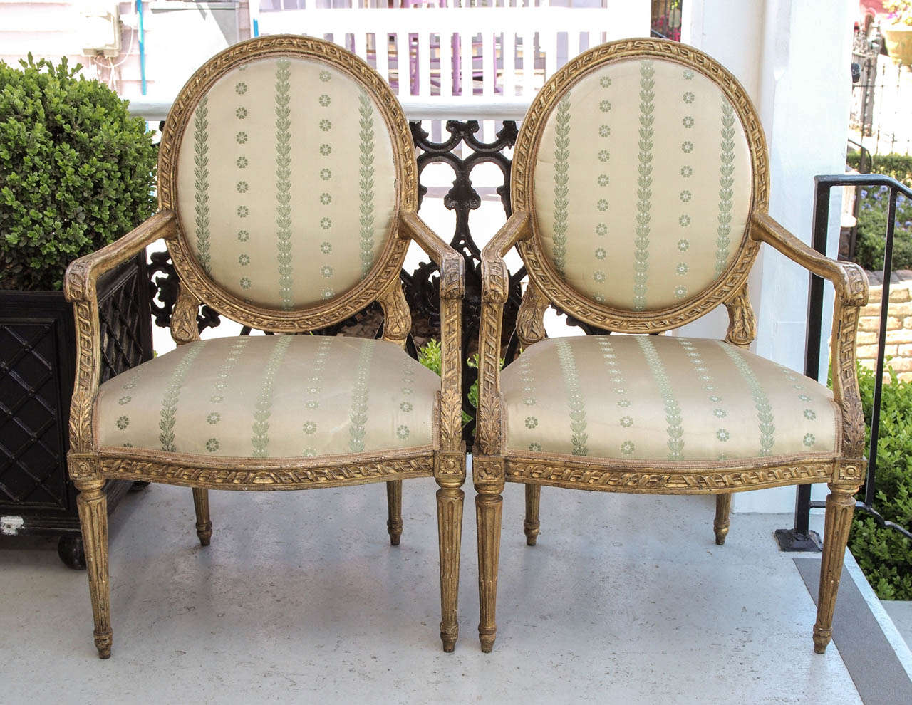 Set of four italian louis xvi gilt oval back armchairs