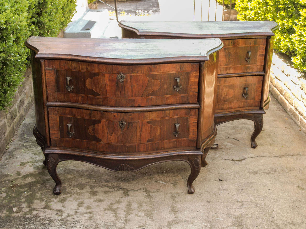 Pair of Serpentine Luigi XV Marquetry Commodini with shaped front and sides and bronze hardware. They have cross banding and inlaid decoration.
all on cabriole legs