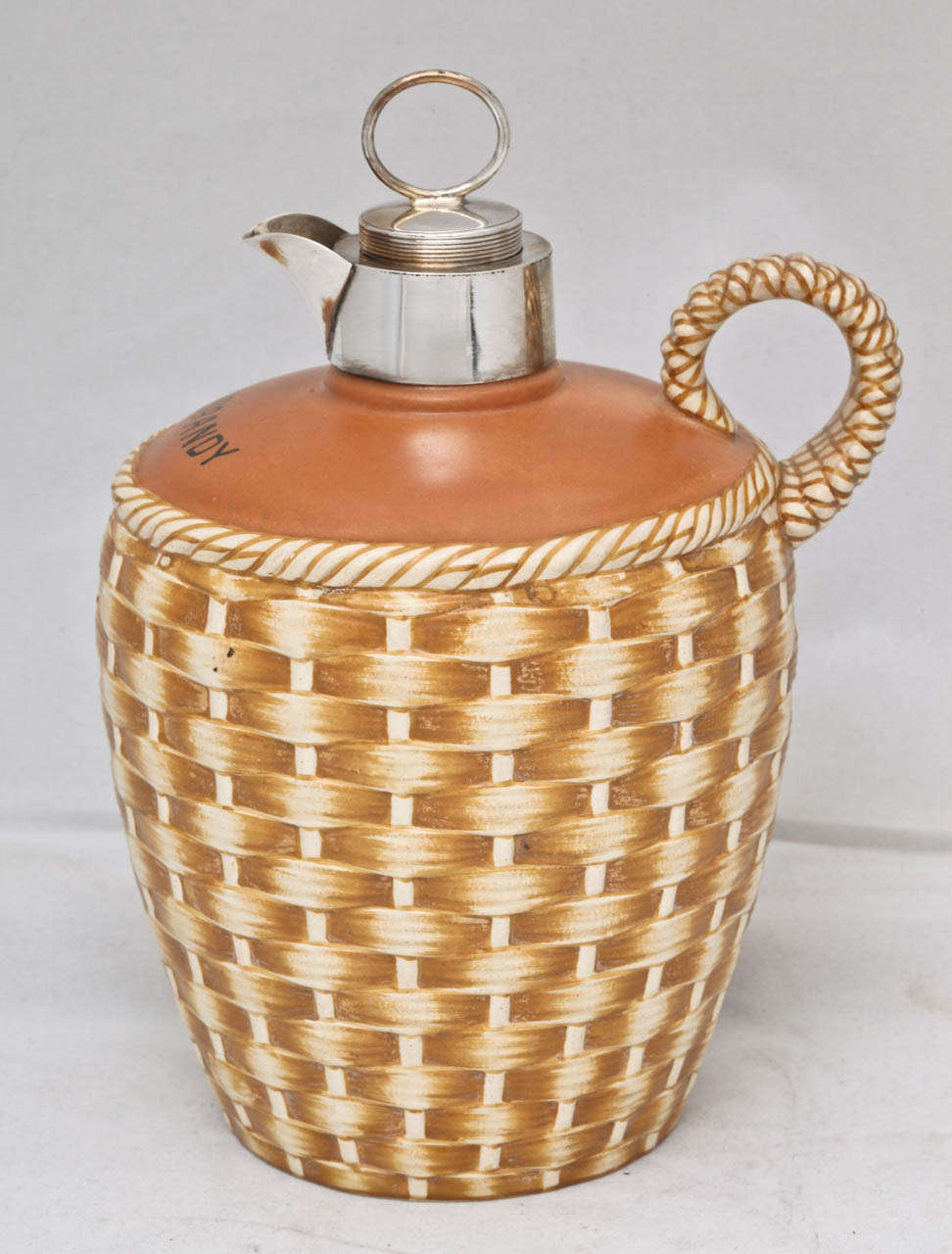 Victorian, sterling silver-mounted, pottery brandy jug, Birmingham, England, 1891, H. Matthews - maker; pottery made by Taylor, Tuncliffe & Co., Staffordshire, England. Pottery designed in three-dimensional 