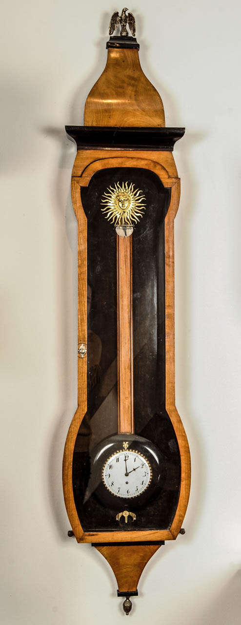 Very unusual Osculating Vienna animated wall regulator, circa 1830.
8 day duration, in the top, sunburst with animated blinking eyes. 
Aprox: 140x17x25