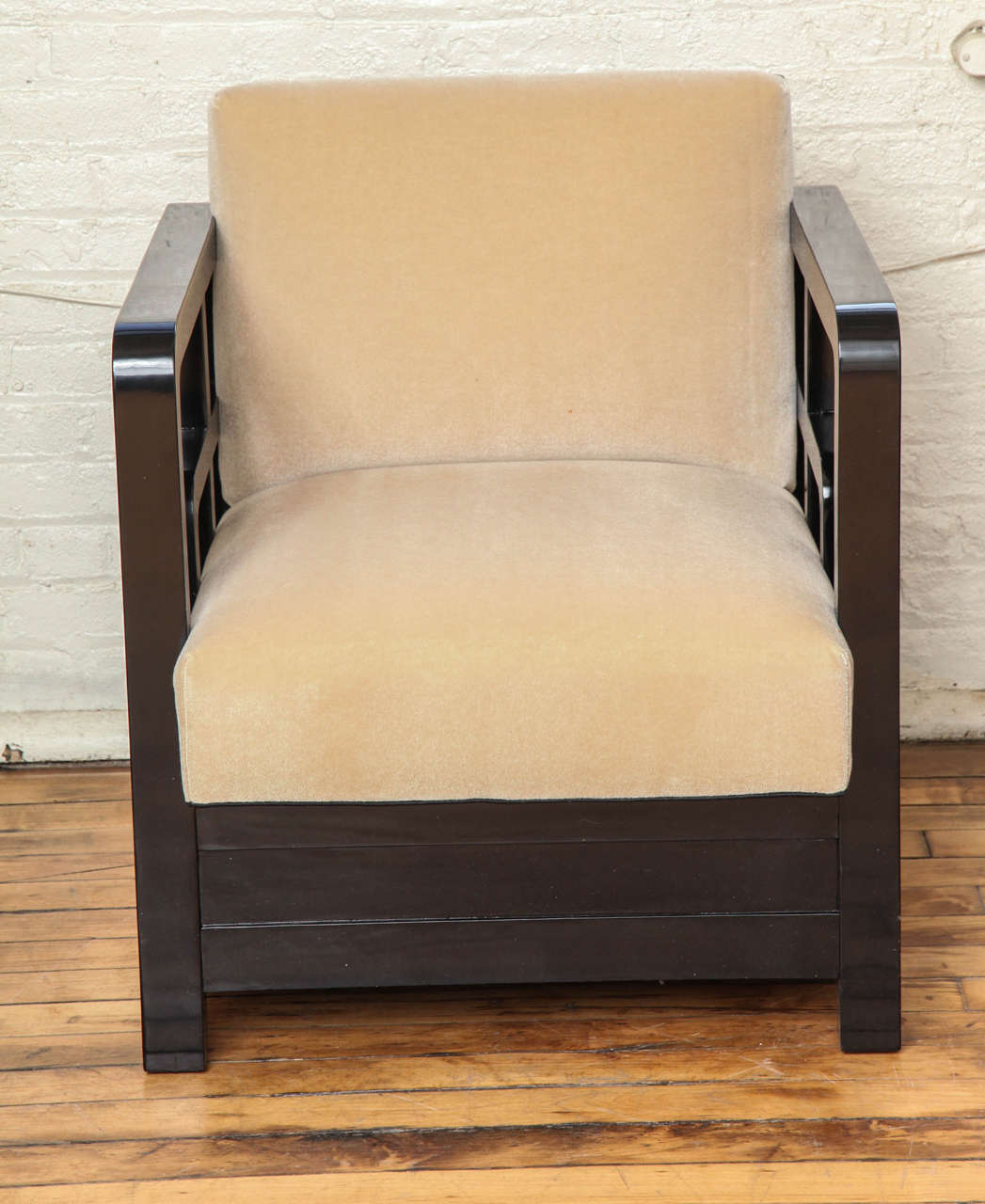 A pair of Asian inspired Art Deco armchairs in ebonized wood.