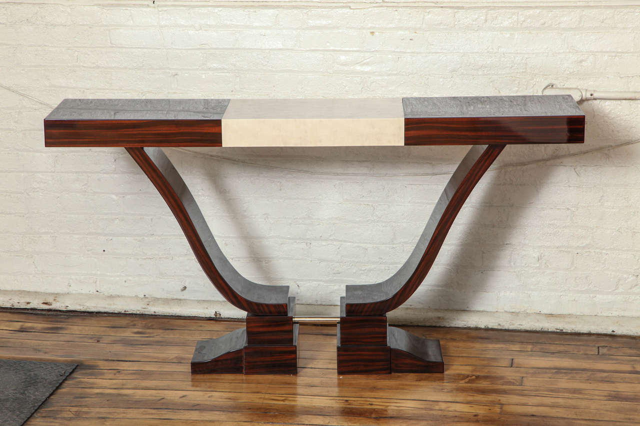 An Art Deco console table in Macassar ebony with parchment center.