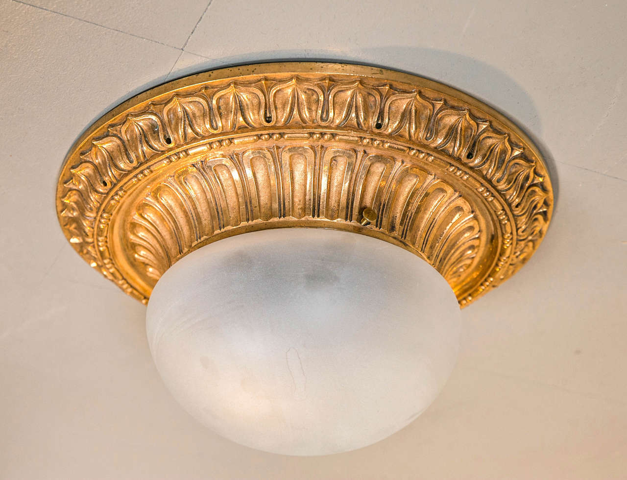 Circa 1900 Caldwell gilt bronze flush mount fixture, with frosted glass insert. Four available.