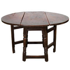 An English Patinated Chestnut and Walnut Gate-leg Side Table