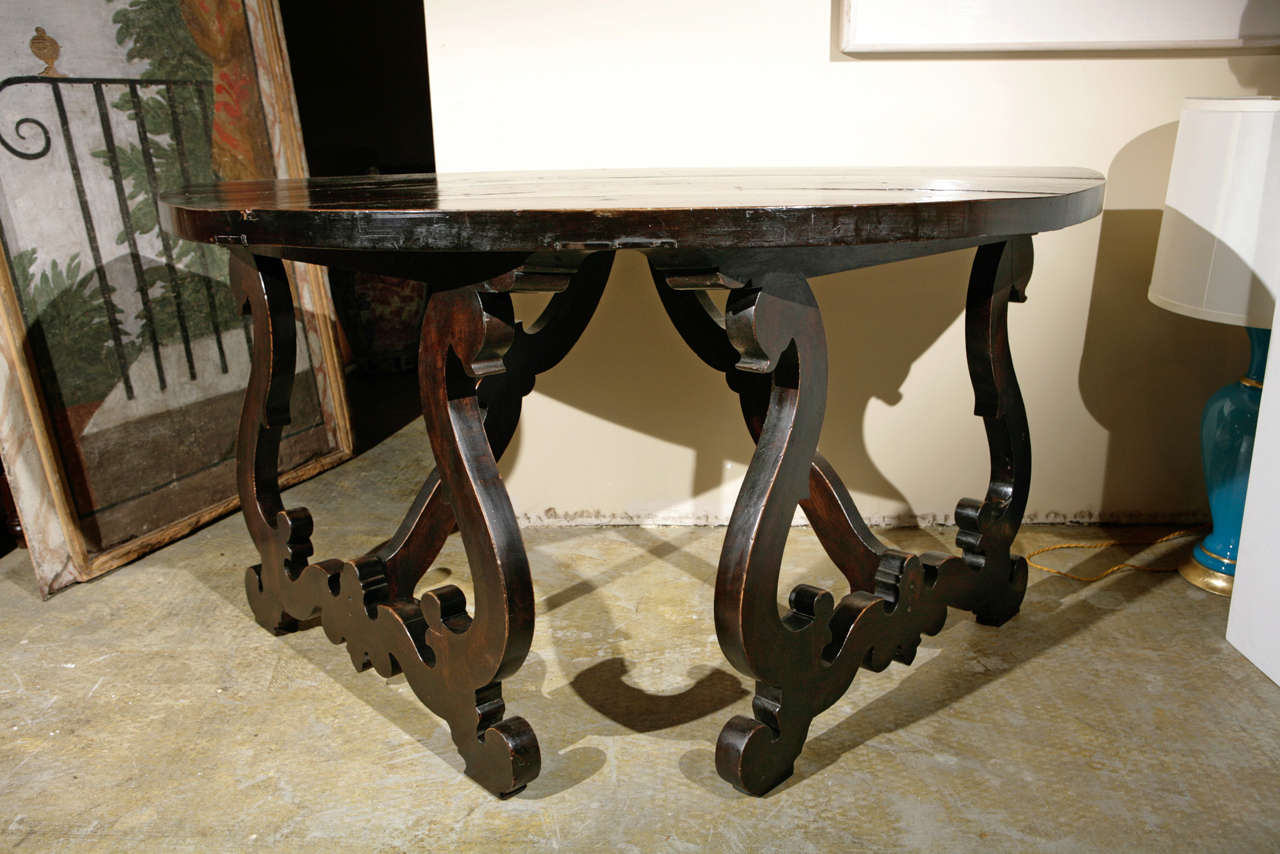Beautiful pair of carved, walnut demilune tables or can be combined to create a single, center table. The thick, polished tops above scrolling, lyre-form legs.

NOTE: Measurement below reflects EACH piece, not the combined total. 