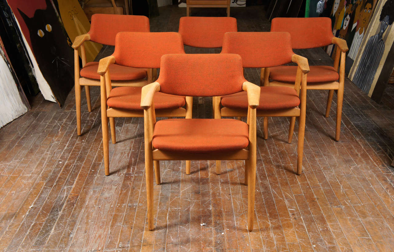 Set of six Danish modern dining chairs covered in oak with original orange wool fabric by Danish designer Erik Kirkegaard, made by Glostrup Fabric. 