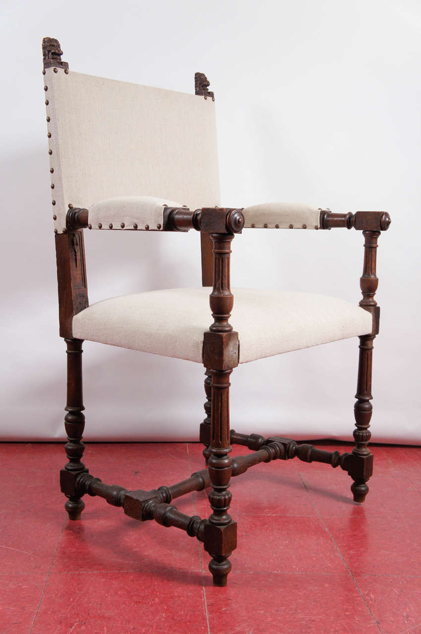 Very comfortable Italian or Spanish renaissance style  throne chair for the hall, desk...you name it.  Turned oak framing, newly upholstered with beige linen and hob nails

Arm height, 29.50.