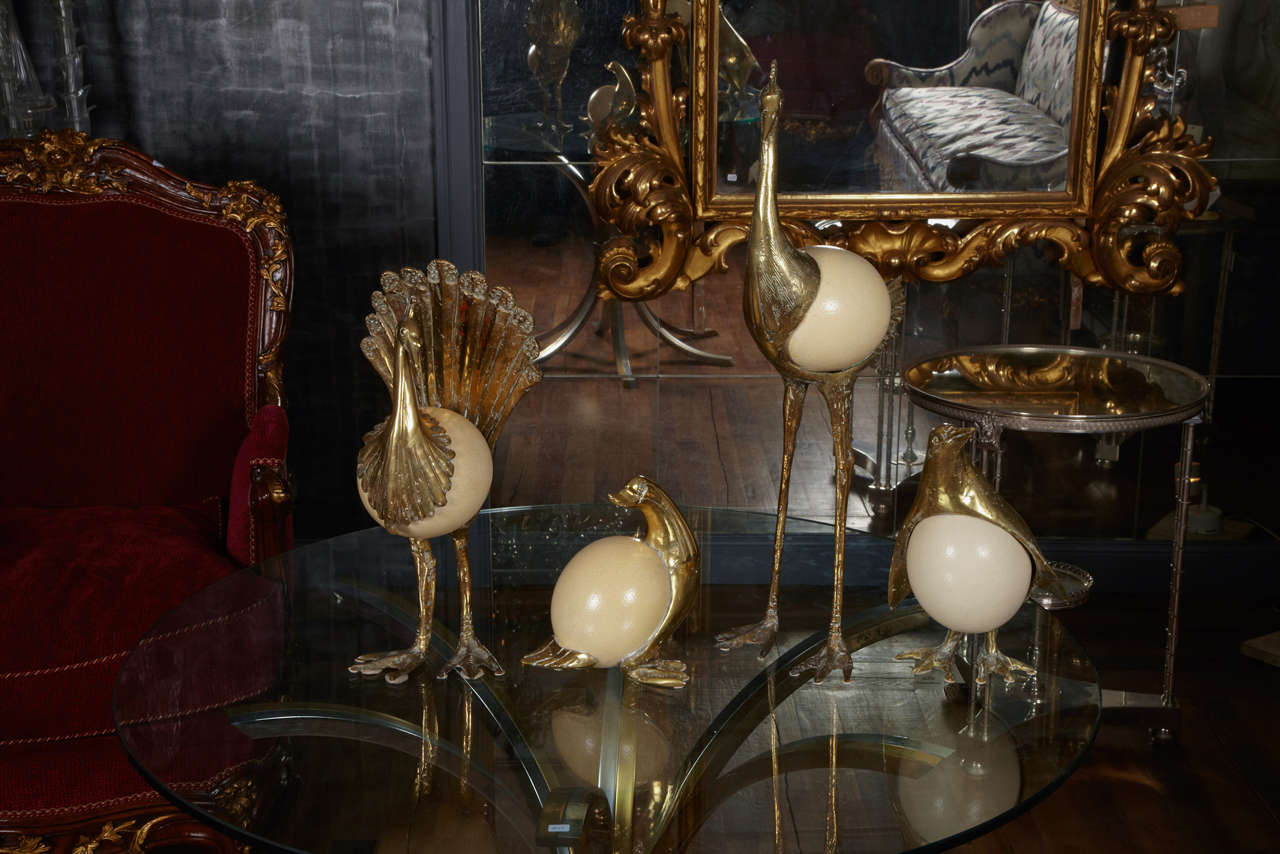 Set of four brass sculptures, inlaid ostrich egg, heron, peacock, duck