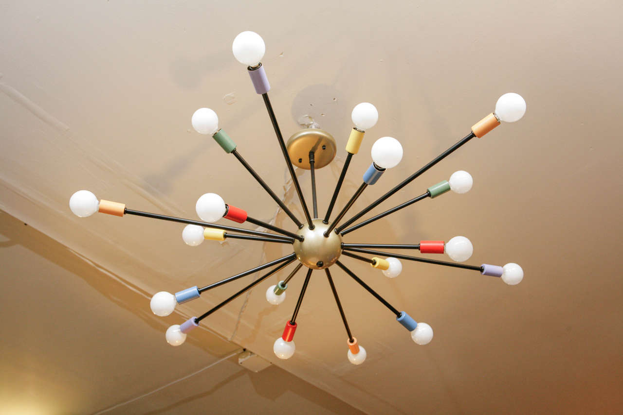 A colorful 18 light sputnik chandelier in black and colored enameled metal with a satin brass center ball and canopy.