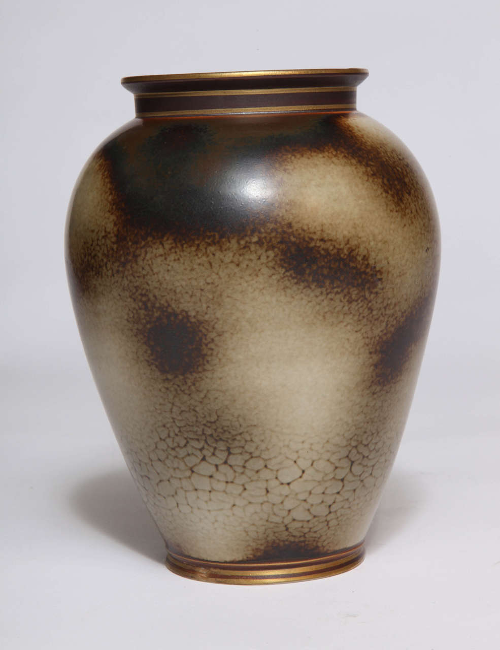 A beautiful ceramic vase with a stunning glaze by Gunnar Nylund for Rörstrand. Sage and brown glaze, with gold trim. Signed.