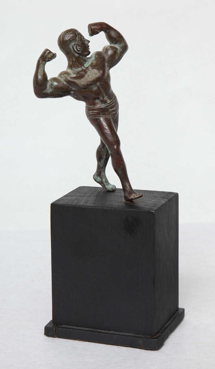 A small Burmese bronze muscleman on a pedestal.