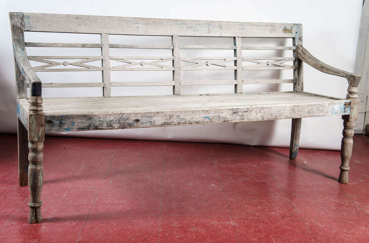 Teak bench with aged wood once painted, turned legs and open lattice back.  Can be used indoor or outdoors.

Seat, 17.50