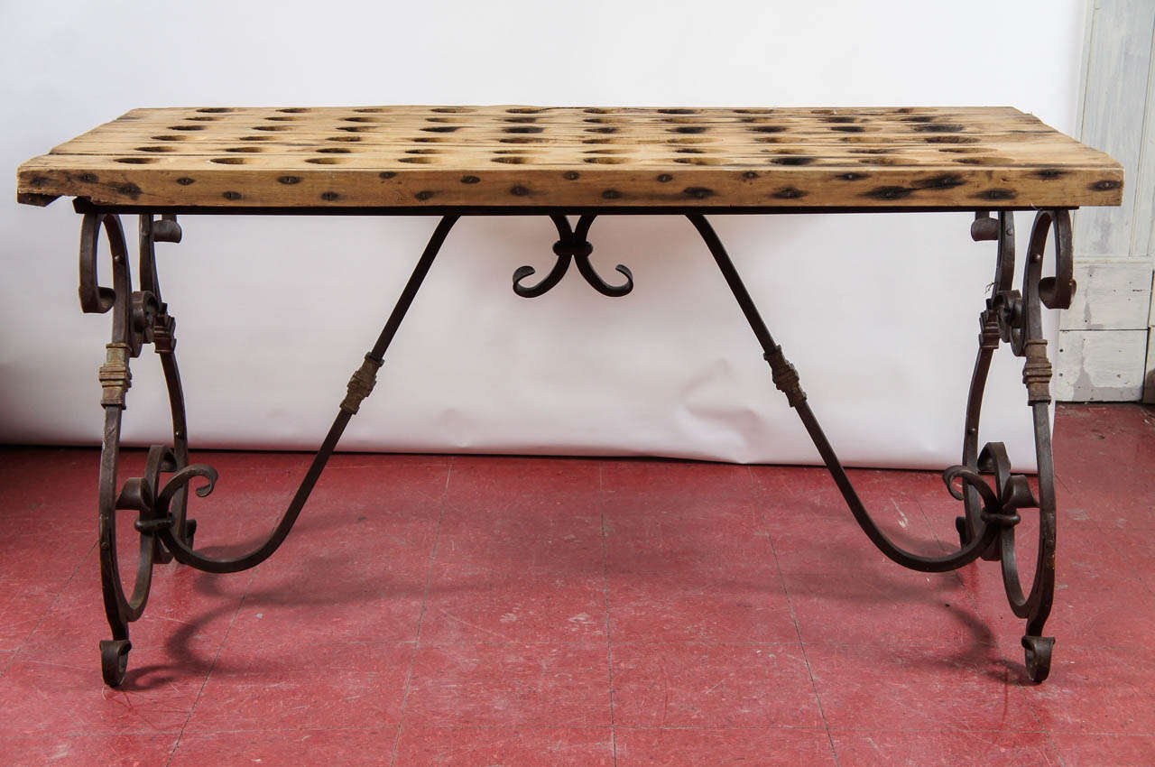 French wrought iron base with antique French champagne riddling rack for a top to to create a one-of-kind serving table.  A glass top can be added and be used as dining table or perfect as a wine tasting table in the wine cellar.