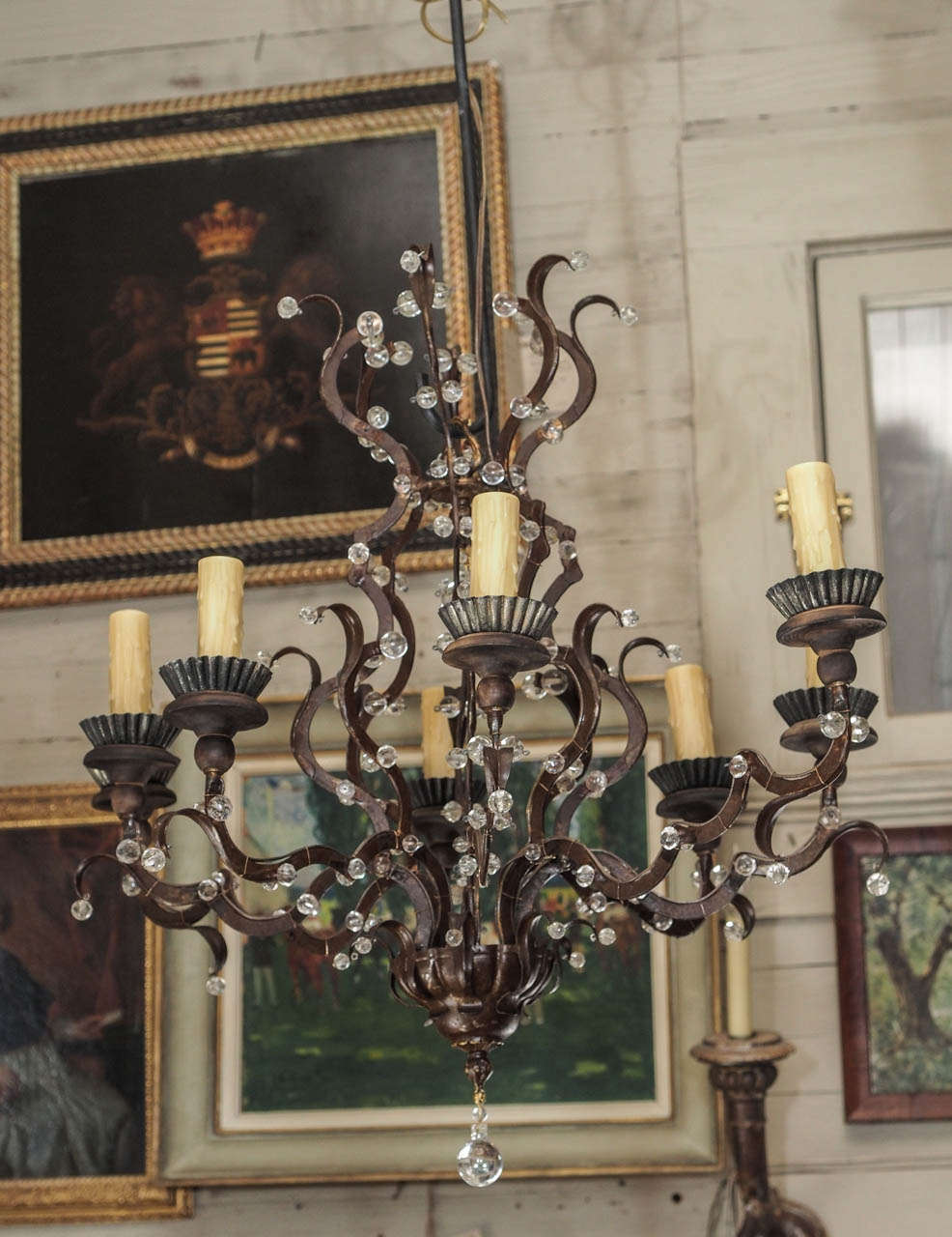 8 arm iron chandelier, the scroll arms adorned with glass beads.
US wired