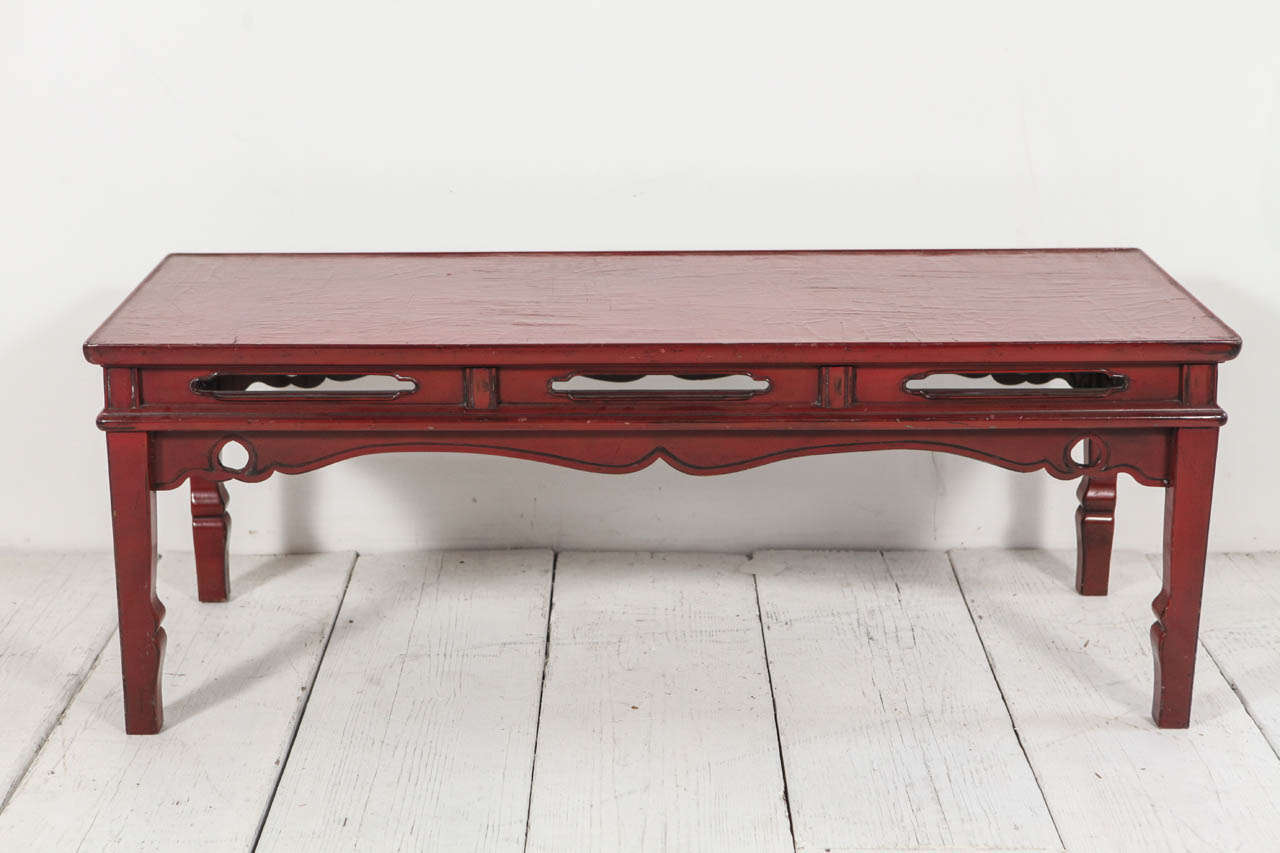 Small scale bench or coffee table in red glaze lacquer.