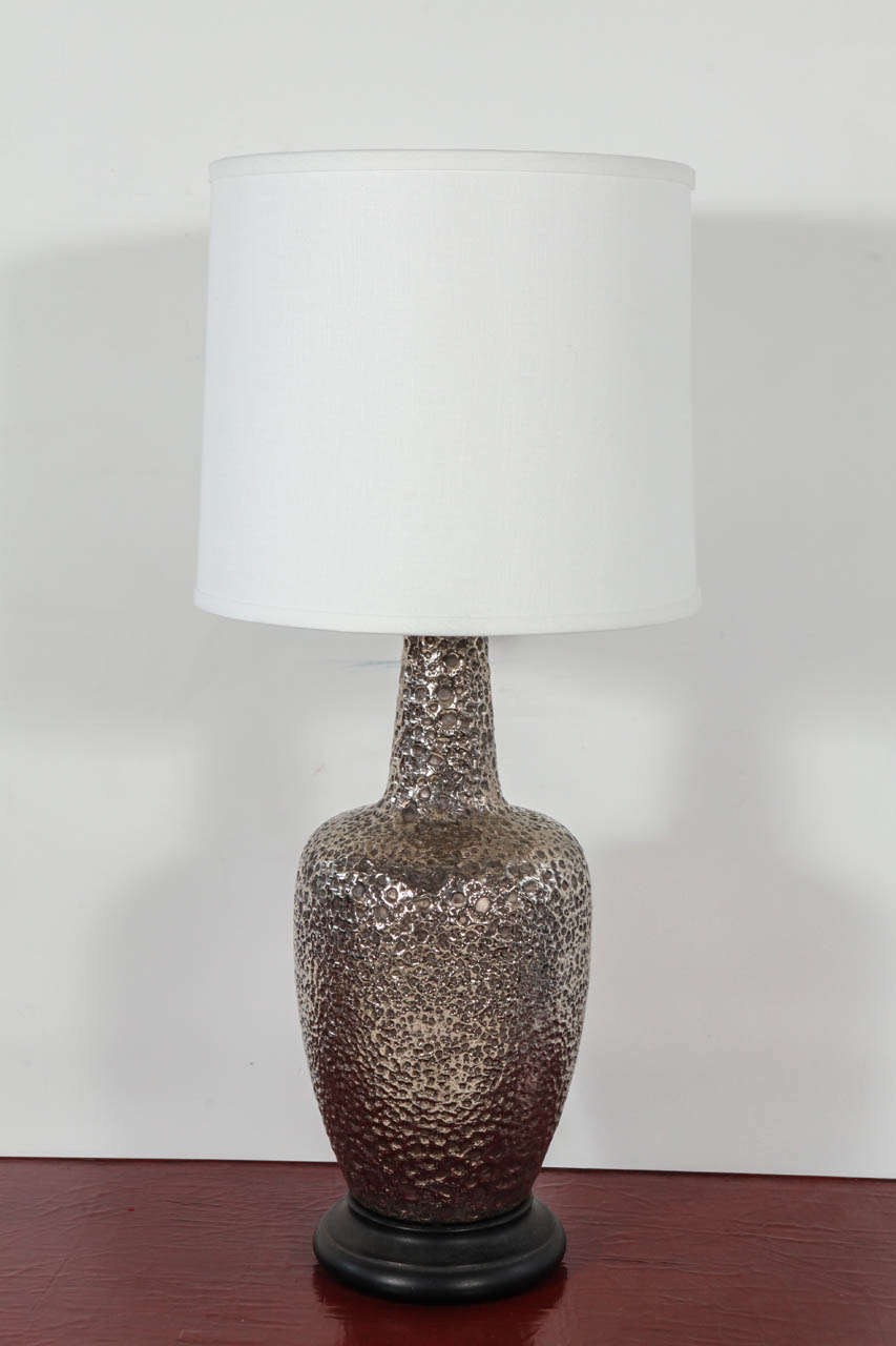 Urn table lamp with mottled silver textural finish. Newly rewired with black silk twist cord. Shade sold separately (approx. $100).

Height to top of socket measures 25