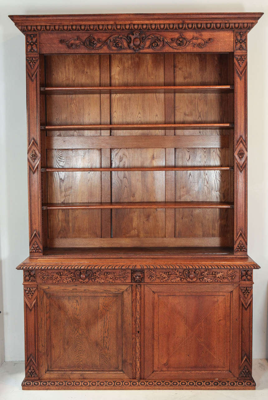 Impressive carved cabinet with adjustable shelves.